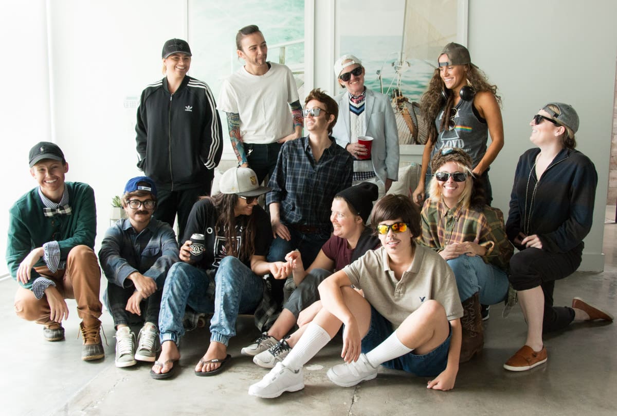 Group of people posing and smiling together.