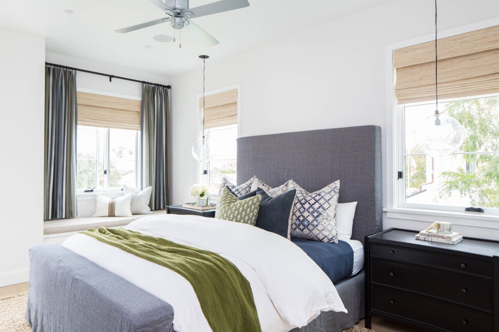 Modern bedroom with large bed and windows.