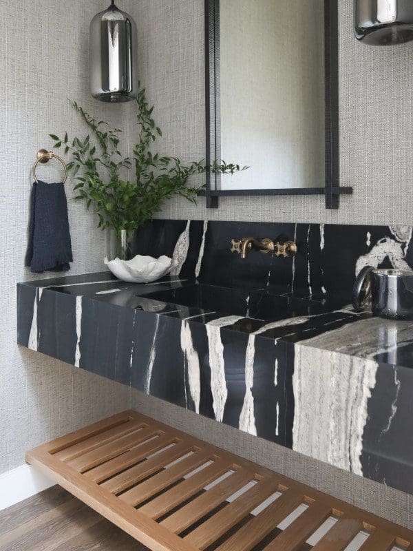 Black marble bathroom vanity with brass faucet