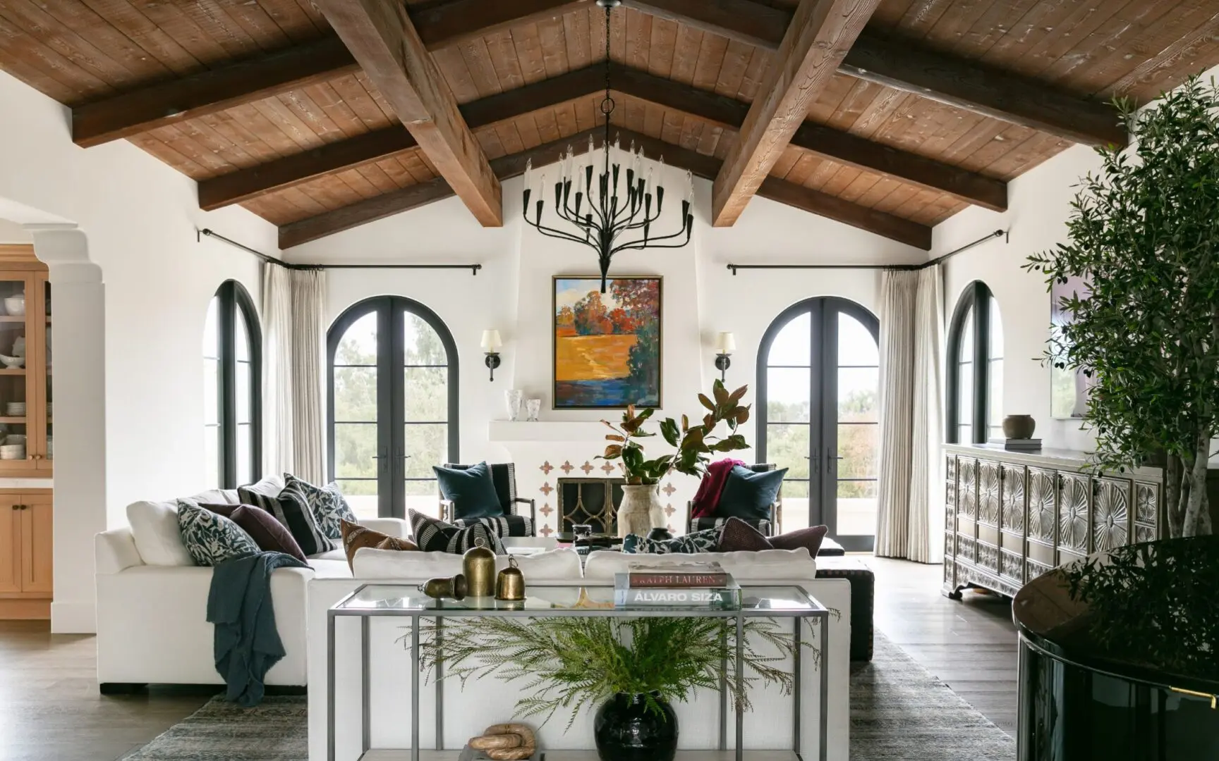 Spanish-style great room with wood ceiling treatment and arched windows.