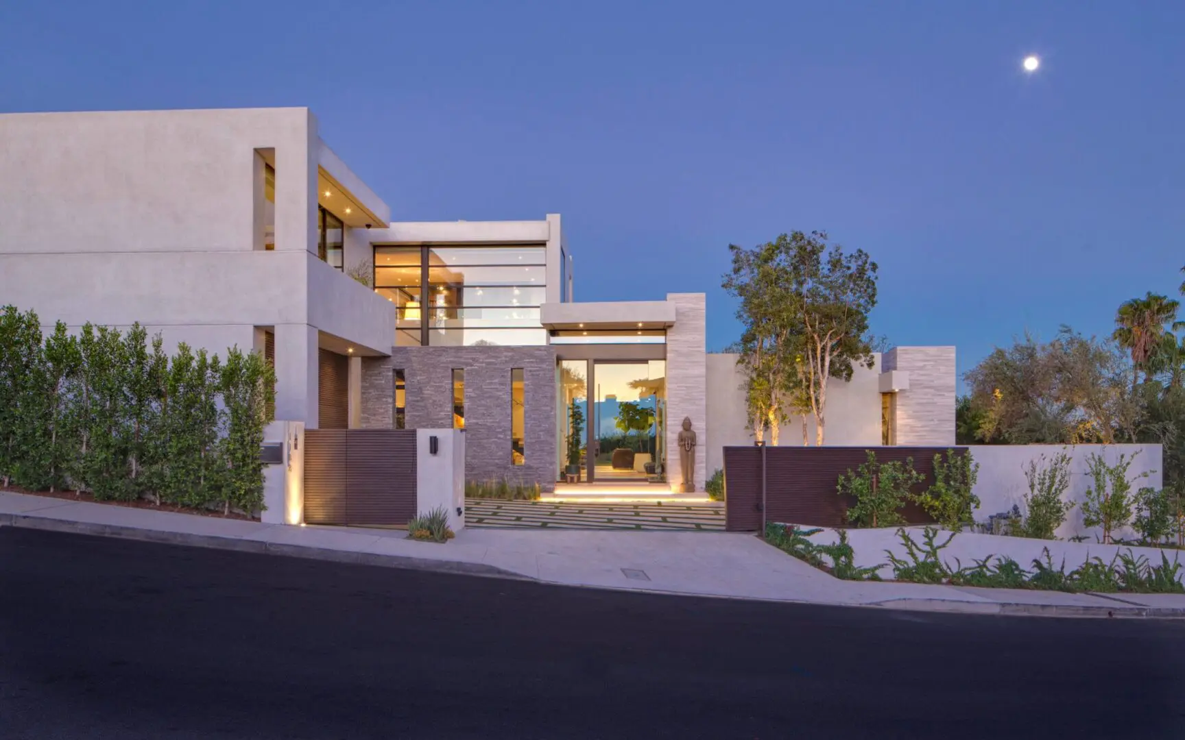 A custom home with contemporary architecture at twilight.