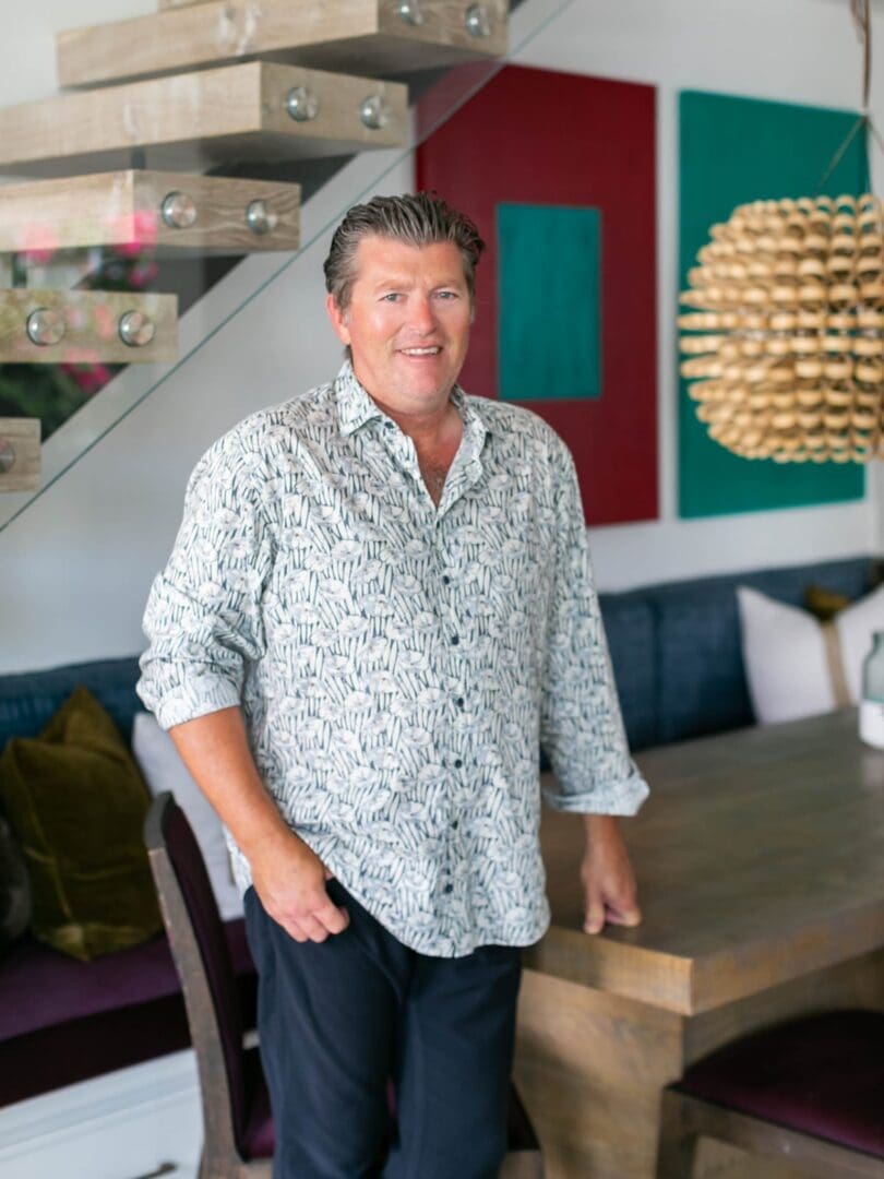 GREG-BLACKBAND-WEBSITE-2020 Blackband Design owner, Greg Blackband, standing next to a dining table.