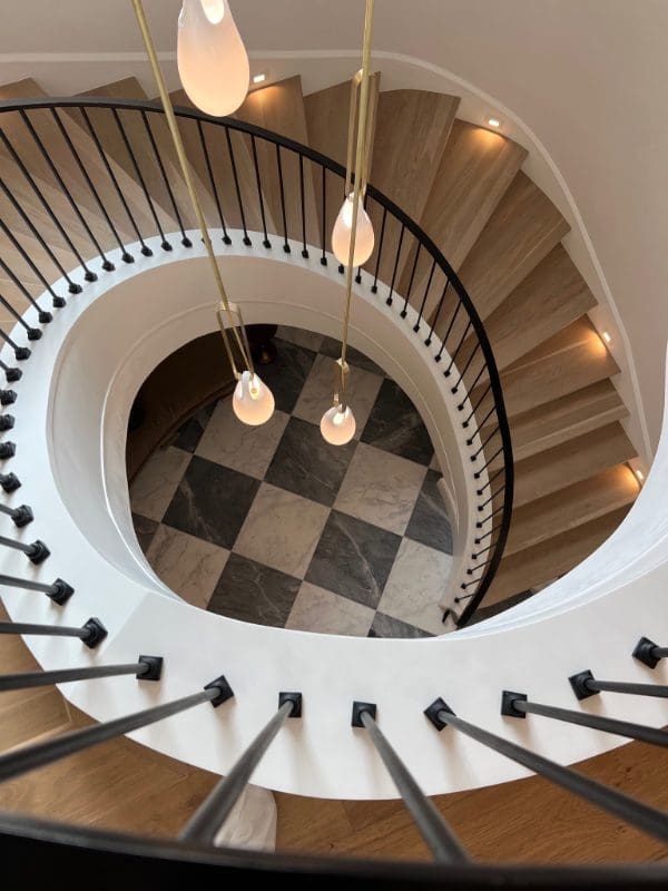 blackband-design-highland-park-dallas-staircase Spiral staircase with black and white checkerboard marble floors.