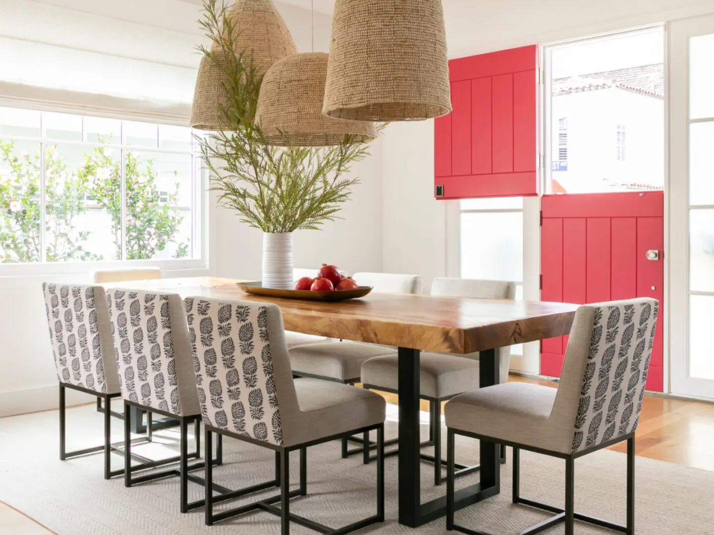 Coastal dining room with beaded pendants and upholstered dining chairs.