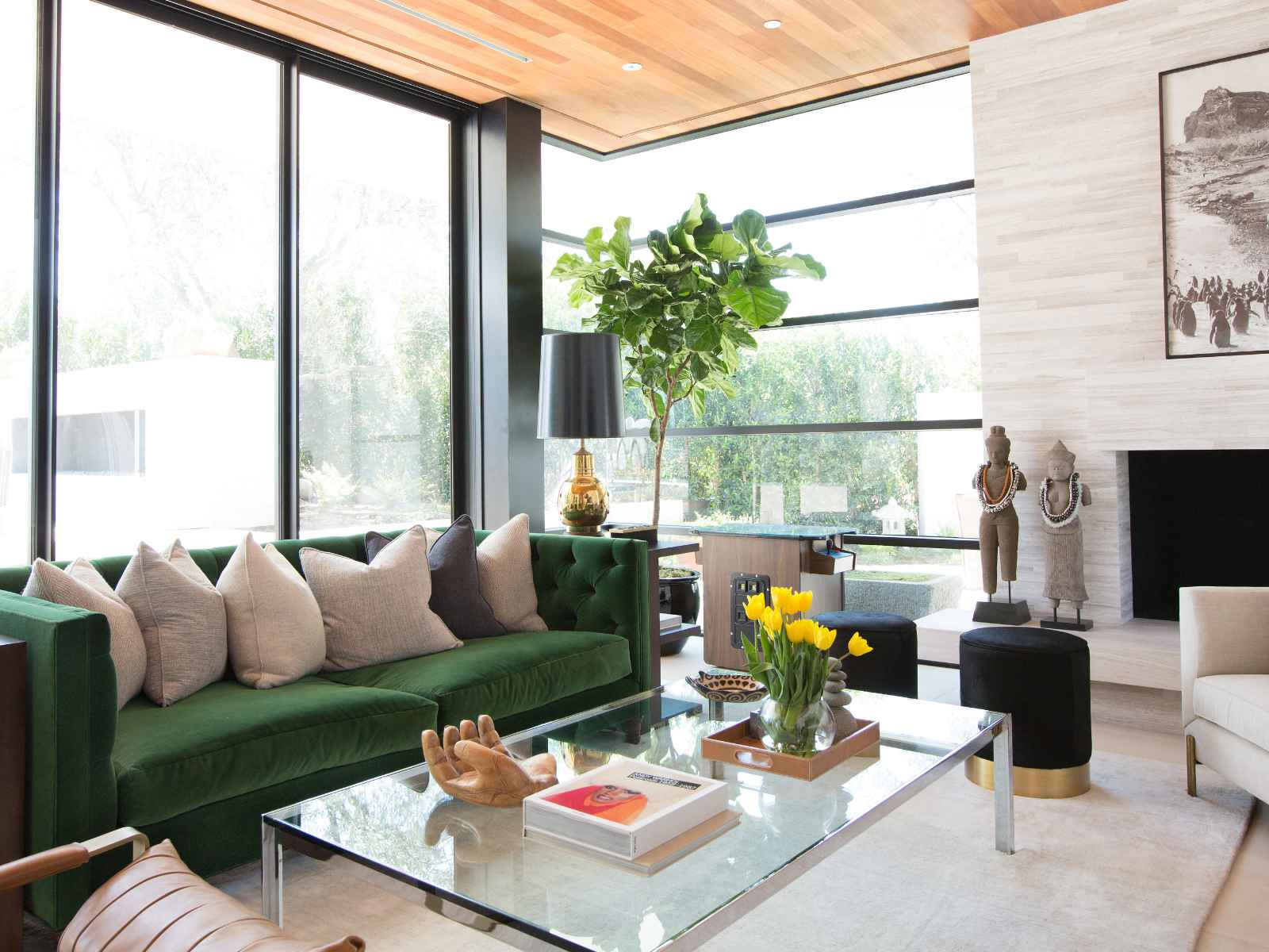 Luxury living room with velvet green sofa and wood ceilings.