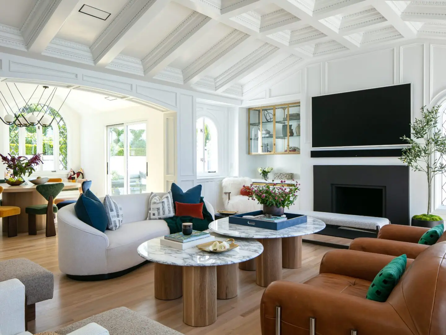Eclectic living room with cathedral coffered ceilings and modern furnishings.