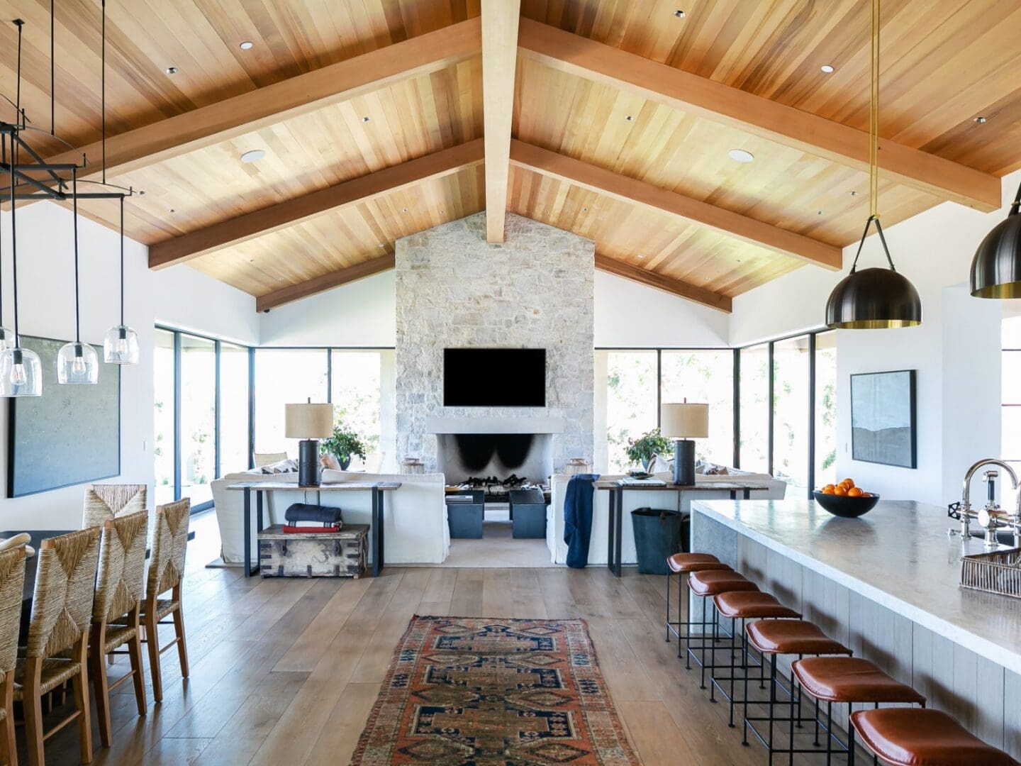 Large great room with wood ceilings and stone fireplace.