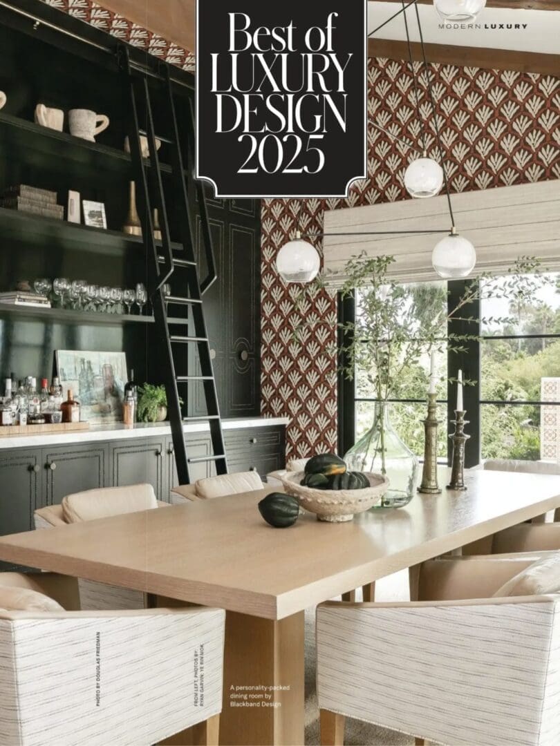 A bold dining room with patterned wallpaper and text reading "best of luxury design 2025."