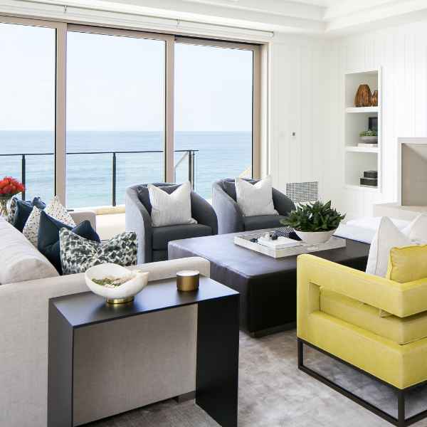 Ocean view living room with comfy seating.