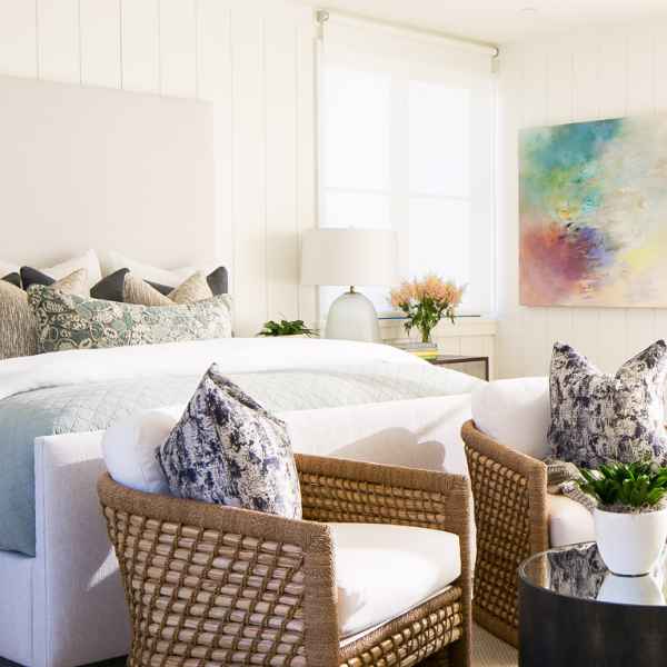 Beachy bedroom with woven chairs.