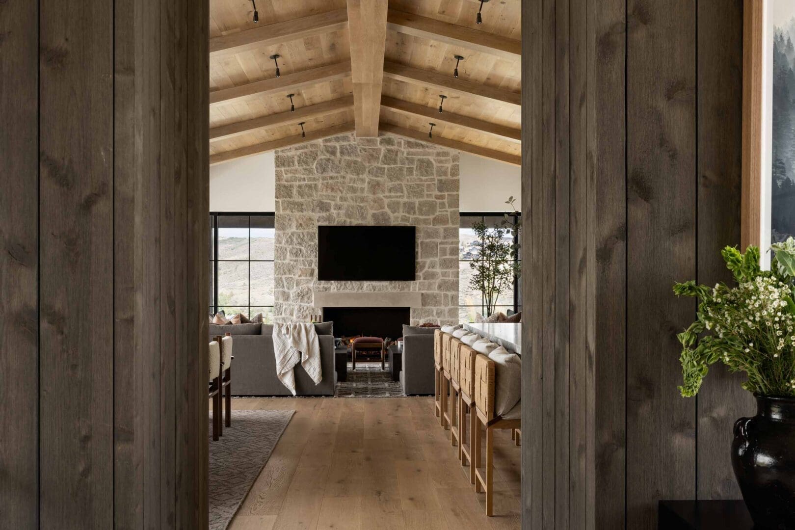 Blackband-Design-Victory-Ranch-Utah-50 Luxury mountain home with wood-paneled walls and a stone fireplace.