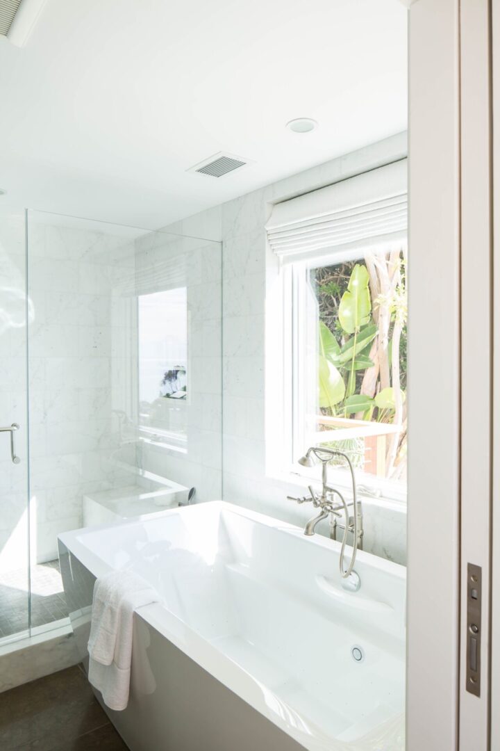White bathtub in a bright bathroom.