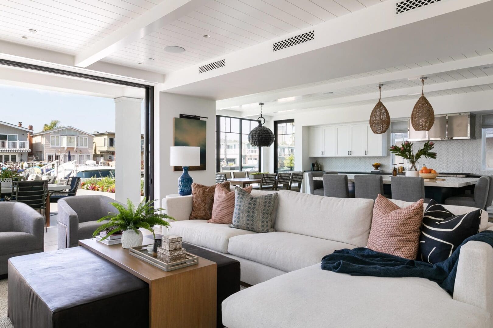 Blackband_Design_Newport_Channel-56 Coastal home great room with sectional sofa and leather ottoman.