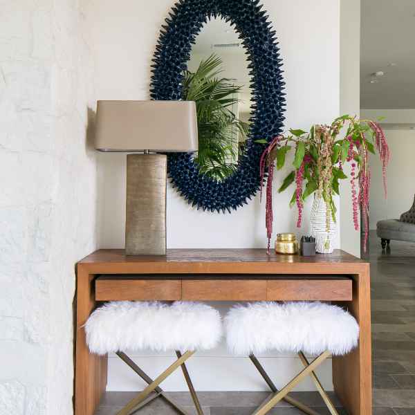 Entryway console with mirror and stools.