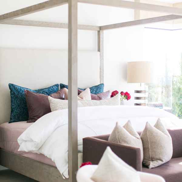 White duvet on four-poster bed.