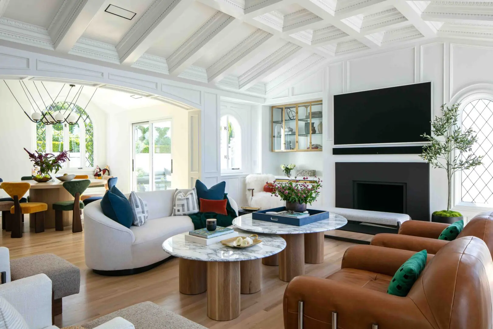 Great room with white coffered ceilings and colorful cutom furniture.