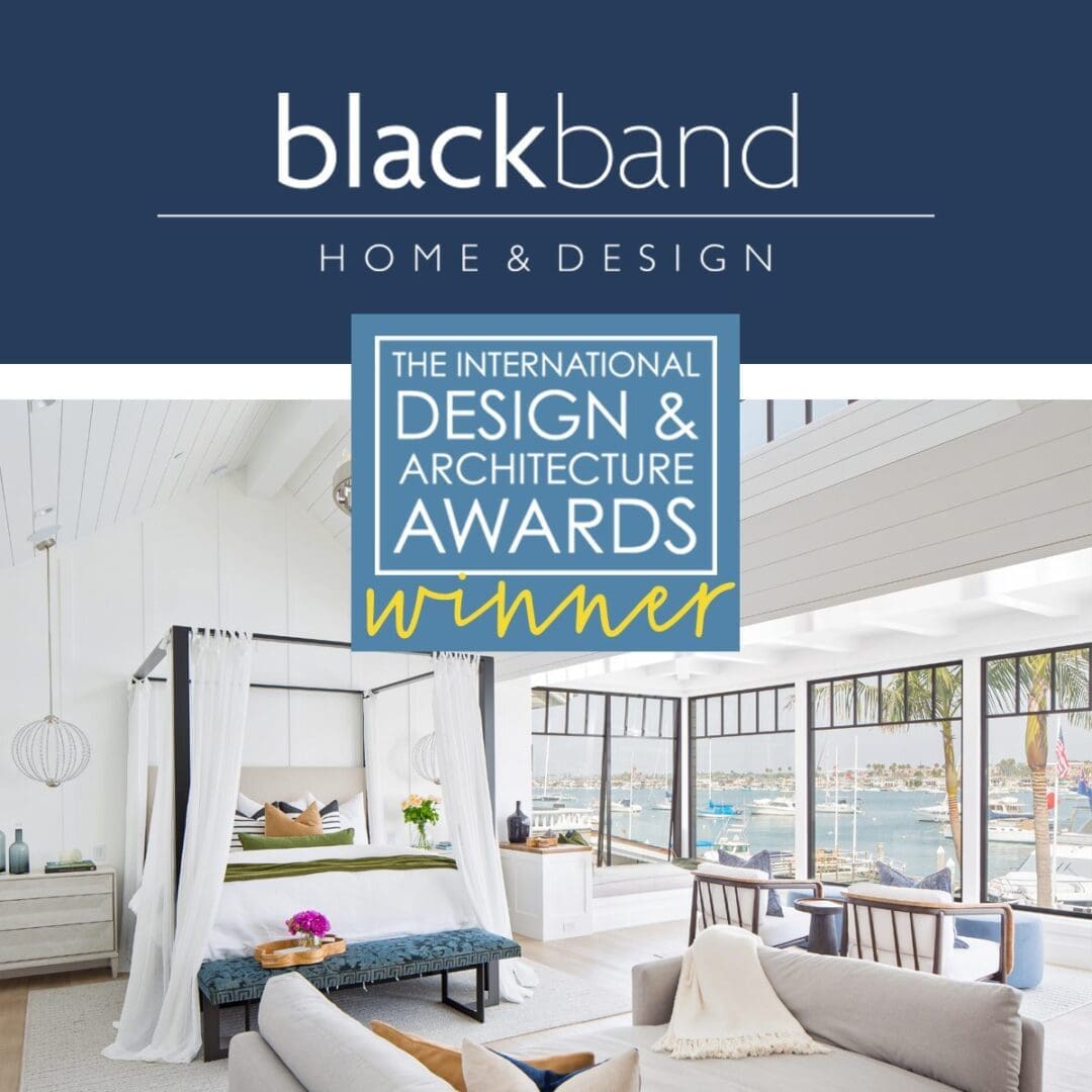 A luxury coastal bedroom with text stating that it won a best of design award.