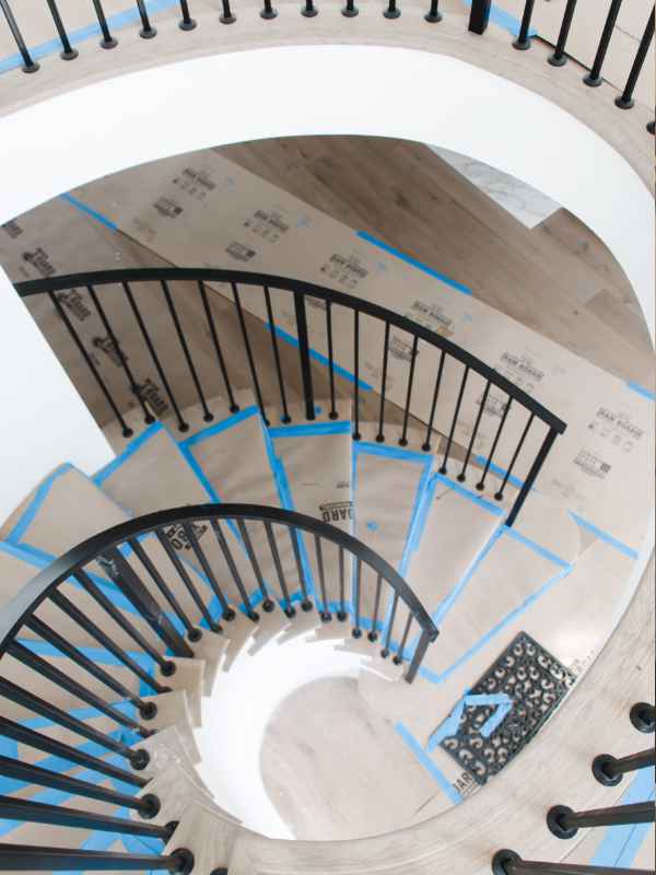 Blackband-Design-Renovation-Balboa-Island-Staircase-Progess Spiral staircase with black railing.
