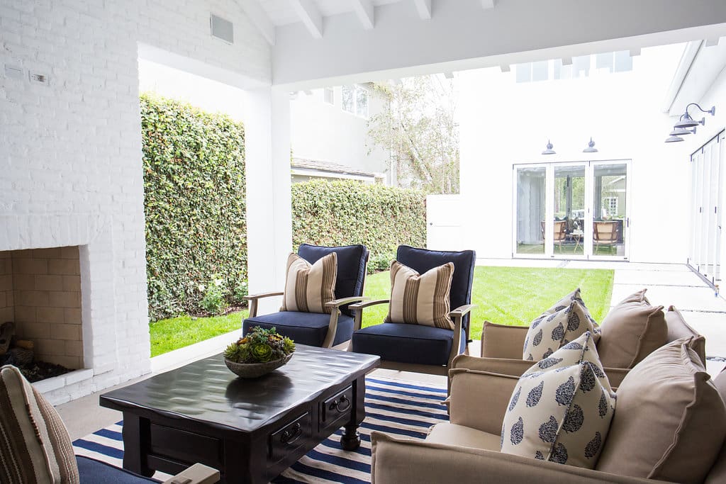 Modern patio with outdoor seating and fireplace.