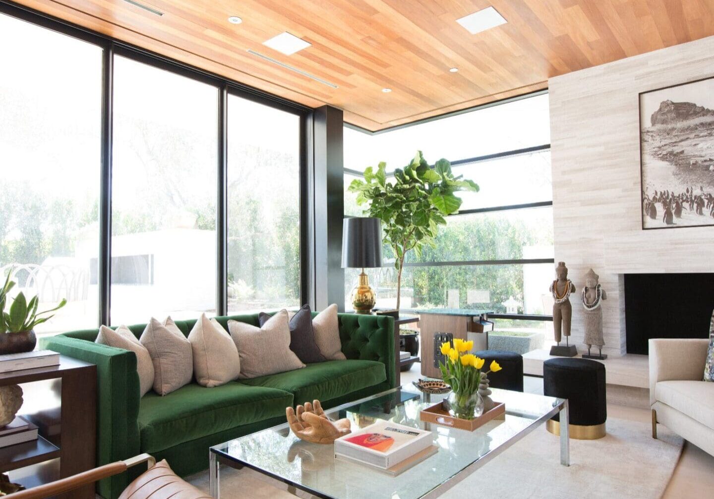 Luxury living room with velvet green sofa and wood ceilings.