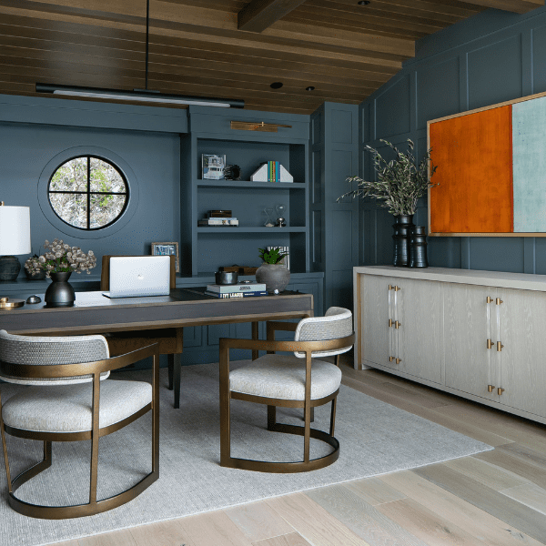 Moody office design with blue-gray walls and a wood ceiling.