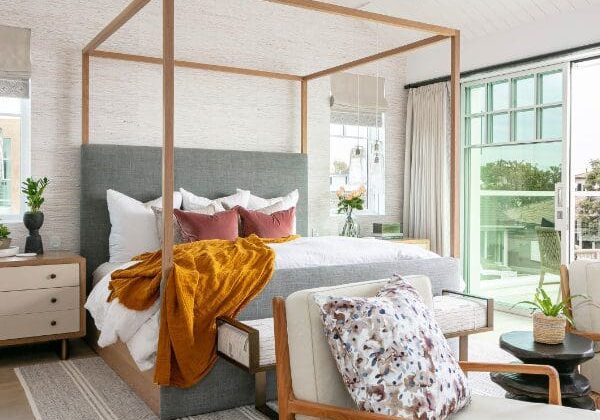 Blackband-Design-Shorecliffs-Bed-Cover Canopy bed with pink pillows and a mustard linen throw blanket.