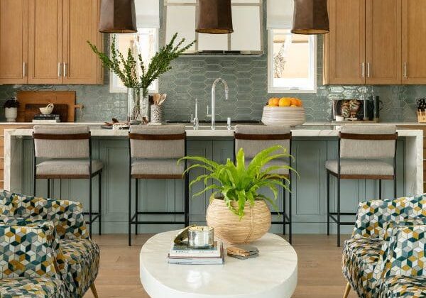 blackband-design-shorecliffs-main-living-cover Blue and wood coastal kitchen with leather pendants.